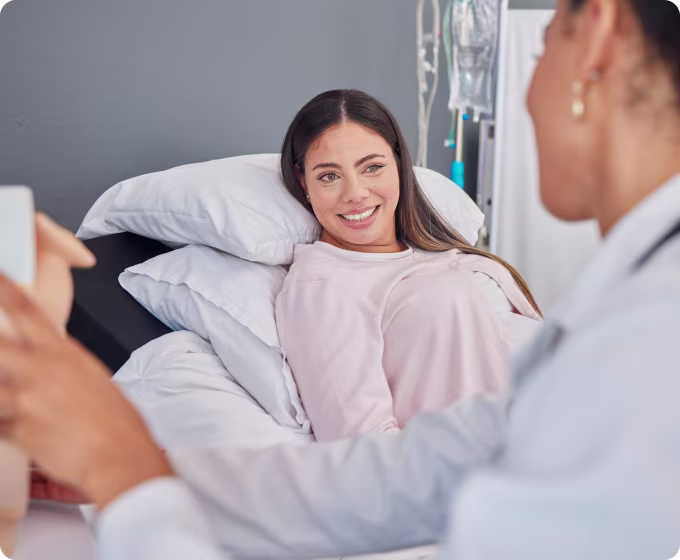 Doctor talking to a patient lying in bed